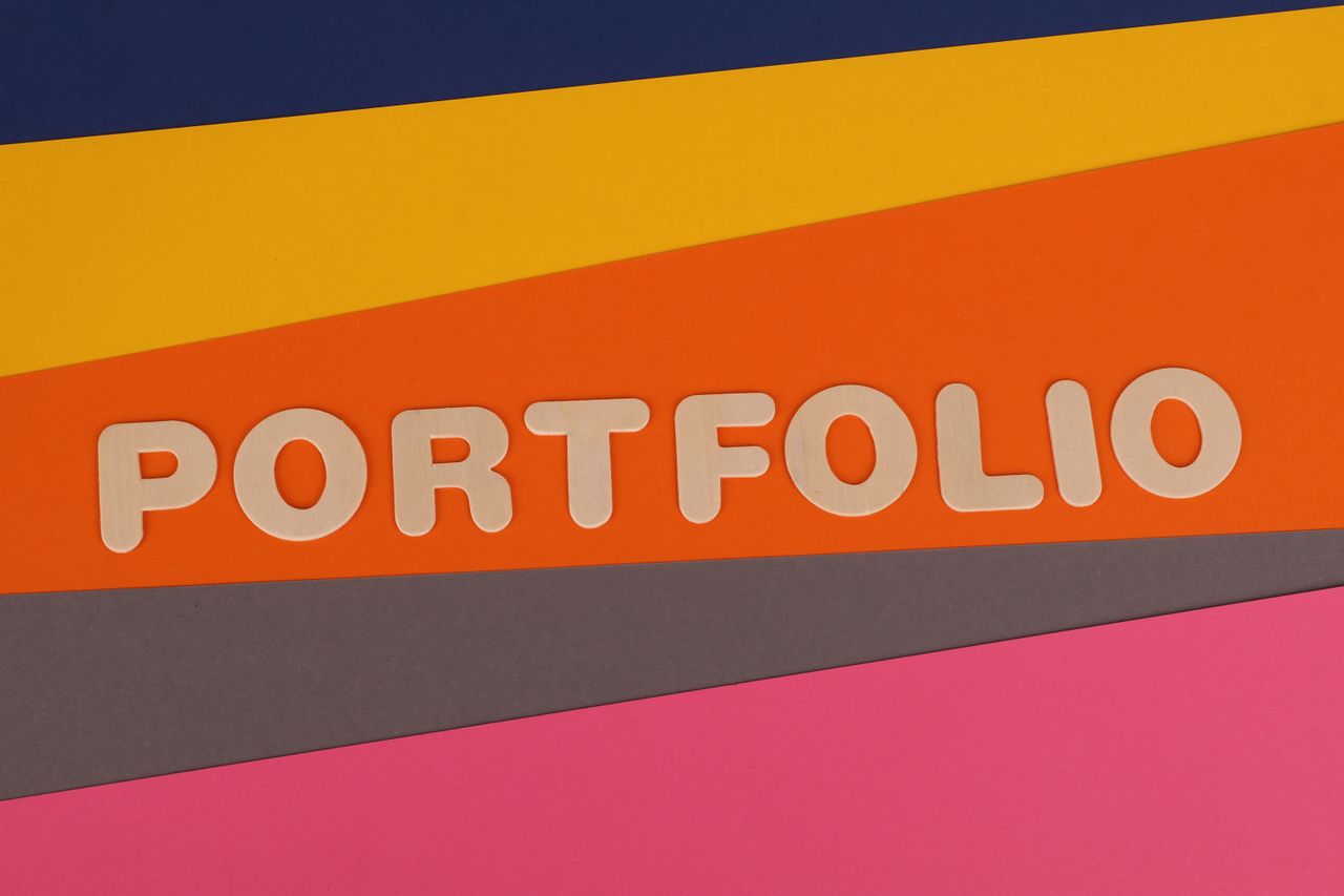A lively multicolored backdrop displaying the word PORTFOLIO in pink lettering on colorful paper.
